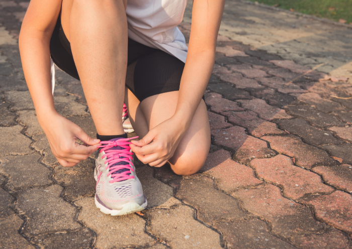 A girl tying her shoes for running